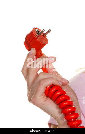 the hand of a woman holding a red power connector. Stock Photo