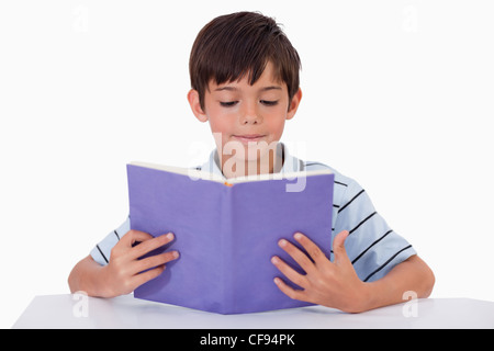 Focused boy reading a book Stock Photo