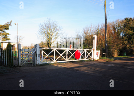 A closed level crossing gate and passenger access gate at Wymondham Abbey Station, Norfolk, England, United Kingdom. Stock Photo