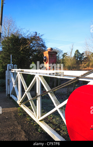 Level crossing gate with warning lantern by Wymondham Abbey Station, Norfolk, England, United Kingdom. Stock Photo