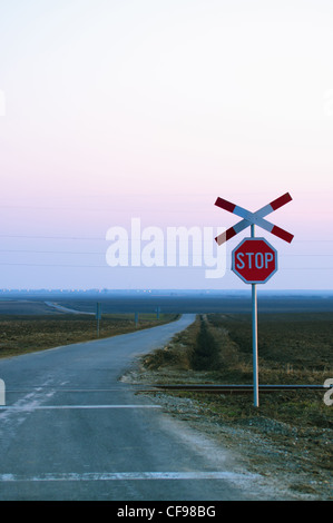 Railway cross and stop sign in middle of nowhere Stock Photo