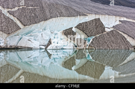 Glacial Ice and reflections in melted water, Iceland Ash from volcanic eruptions, Fimmvorduhals by Eyjafjallajokull Stock Photo