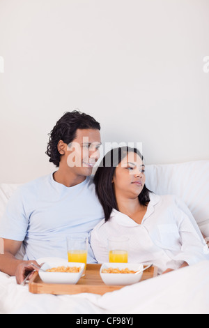Couple eating breakfast in the bed Stock Photo