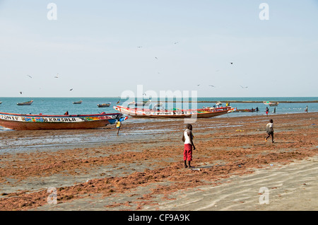 Fishing boats moored up on the beach at Tanji village Gambia west Africa Stock Photo