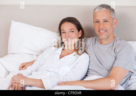Couple lying on a bed Stock Photo