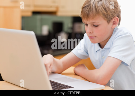 Focused boy using a laptop Stock Photo