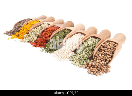 Row of wooden shovels with spices in them. Diminishing perspective Stock Photo