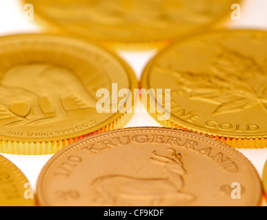 Small pure gold bullion coins in gold flakes Stock Photo - Alamy