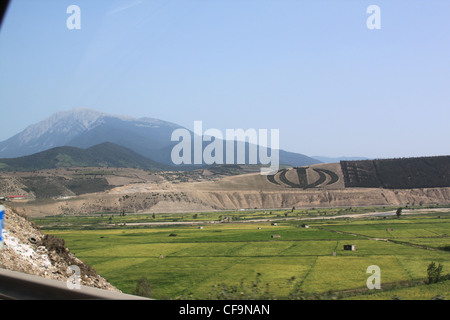 Allah emblem in trees in Iranian countryside with rice paddy fields and ...