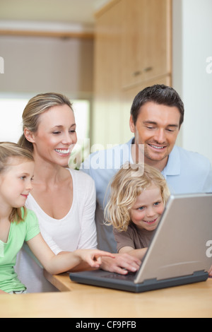 Family using laptop in the kitchen Stock Photo