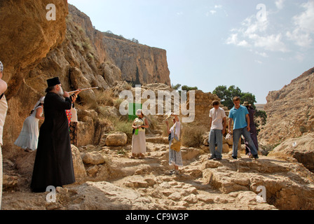 Pilgrims in the Holy Land climbing up to the Skete of St. Hariton on the cliffs of Fara in the Judean Desert, Israel Stock Photo
