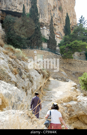 Pilgrims climbing up to the Skete of St. Hariton in the Holy Land Stock Photo