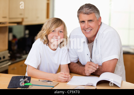Man helping his son with homework Stock Photo