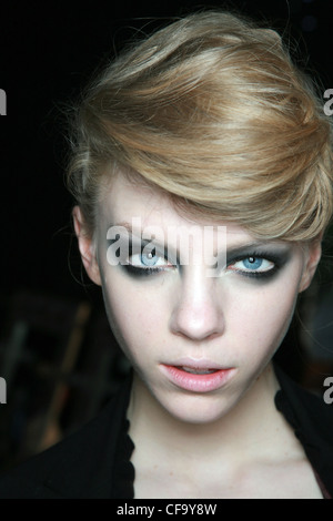 Peter Jensen Backstage London Ready to Wear Autumn Winter Head shot of blonde female quiffed hair, heavy eye make up and pale Stock Photo