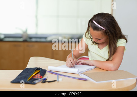 Girl doing homework in the kitchen Stock Photo