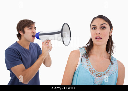 Man yelling at her girlfriend through a megaphone