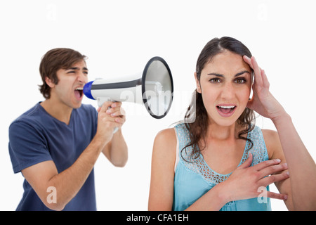 Man shouting at her girlfriend through a megaphone