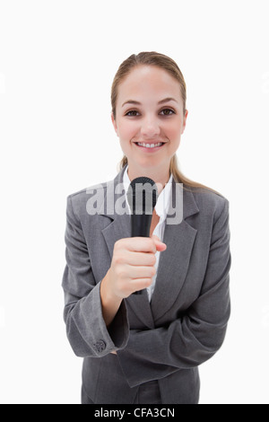 Smiling woman holding microphone Stock Photo