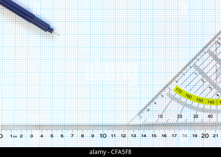 Still life photo of engineering graph paper with a fine 0.1mm pen, protractor and ruler Stock Photo