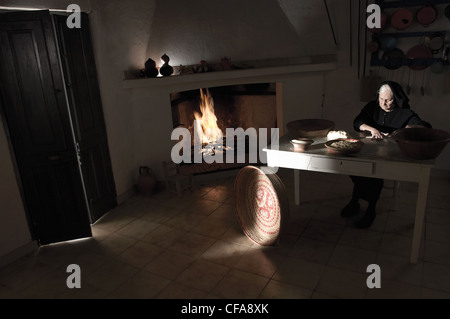 Woman rolling pasta dough in kitchen Stock Photo