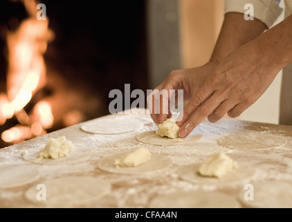 Cook filling pasta dough in kitchen Stock Photo