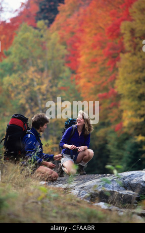 Young couple hiking in autumn at Algonquin Park, Ontario, Canada. Stock Photo