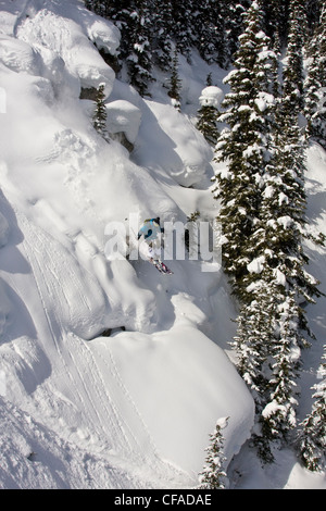 A male skier catches some air in the Sunshine Village Backcountry, Banff, AB Stock Photo