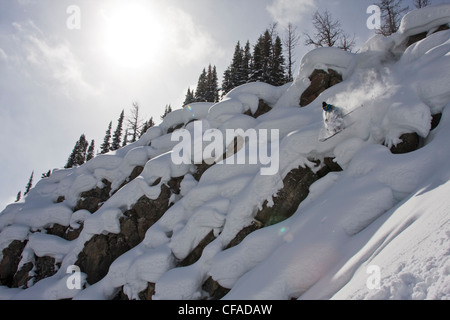 A male skier catches some air in the Sunshine Village Backcountry, Banff, AB Stock Photo