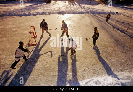 Boys playing hockey on outdoor rink, Winnipeg, Manitoba, Canada. Stock Photo