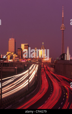 Dusk and rush hour traffic with skyline of Toronto, Ontario, Canada. Stock Photo