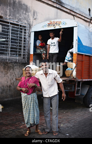 Smiling couple walking on city street Stock Photo