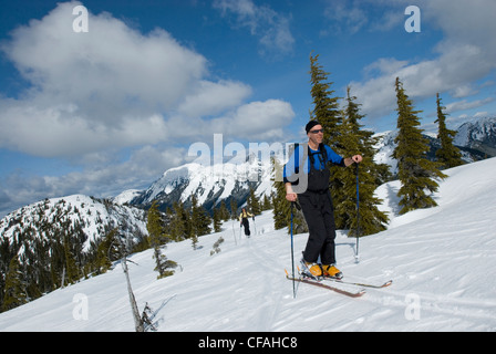 Skiers heading for Great Bear Peak, Cascade mountains near the Coquihalla summit, British Columbia, Canada. Stock Photo