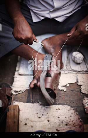 Close up of man repairing shoe Stock Photo