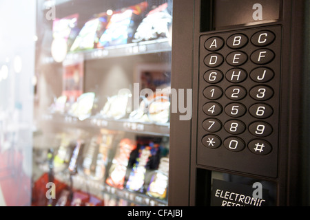 close up of vending machine which dispenses chips and chocolate bars, Montreal, Quebec, Canada Stock Photo