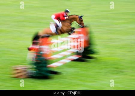 Horse and rider jumping over fence, International Ring, Spruce Meadows, Calgary, Alberta, Canada. Stock Photo