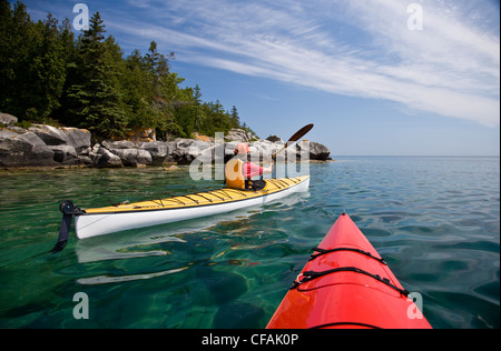 Kayaking in Georgian Bay along Niagara Escarpment near Tobermory, Bruce Penninsula, Ontario, Canada. Stock Photo