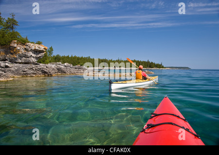 Kayaking in Georgian Bay along Niagara Escarpment near Tobermory, Bruce Penninsula, Ontario, Canada. Stock Photo