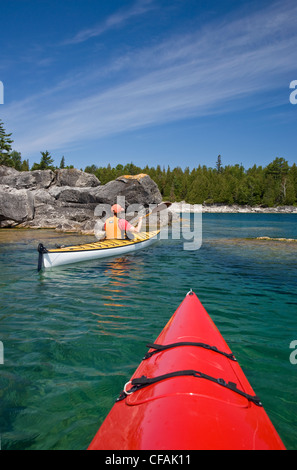 Kayaking in Georgian Bay along Niagara Escarpment near Tobermory, Bruce Penninsula, Ontario, Canada. Stock Photo