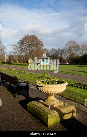 Large flower pot in foreground with Weston park bandstand in background Sheffield South Yorkshire Stock Photo