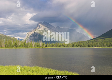 A beautiful rainbow over Mount Rundle in Banff national park, Alberta, Canada Stock Photo