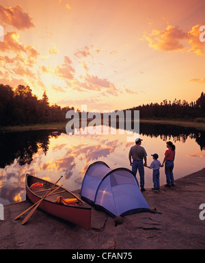 Family camping on riverbank, Whiteshell River, Whiteshell Provincial Park, Manitoba, Canada Stock Photo