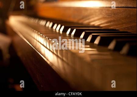 Closeup of antique piano keys and wood grain with sepia tone Stock Photo