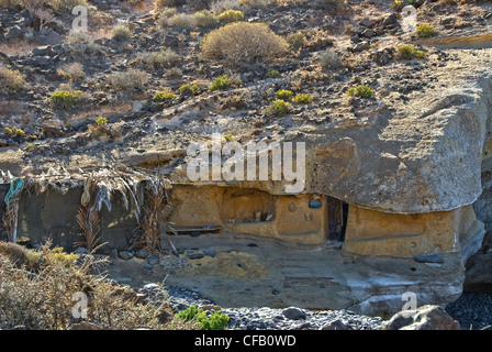 Cave dwelling hewn out of the rock on a beach in Tenerife. Rocky cavern. Stock Photo