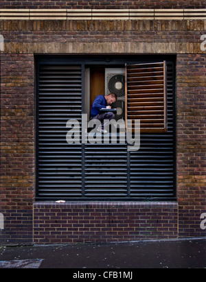 Man repairing air conditioning, London Stock Photo