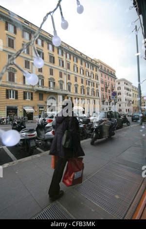Woman carrying shopping bags in Rome Italy at Christmas time Stock Photo