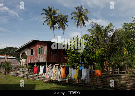 Traditional native Iban and Dayak family in a longhouse in Borneo, Malaysia Stock Photo