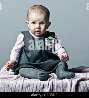 Beauty Baby girl in Grey Dress Stock Photo