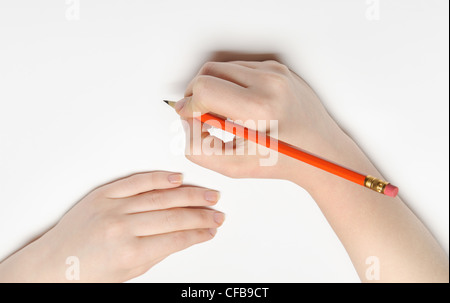 Hand with pencil. Over grey empty a paper. Imitation to write Stock Photo