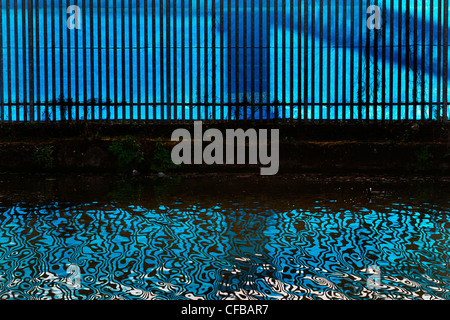 Reflections of fence in canal, London, UK. Stock Photo
