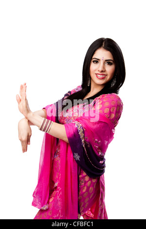 Happy smiling beautiful Bengali Indian Hindu woman in colorful dress in dance pose, isolated Stock Photo